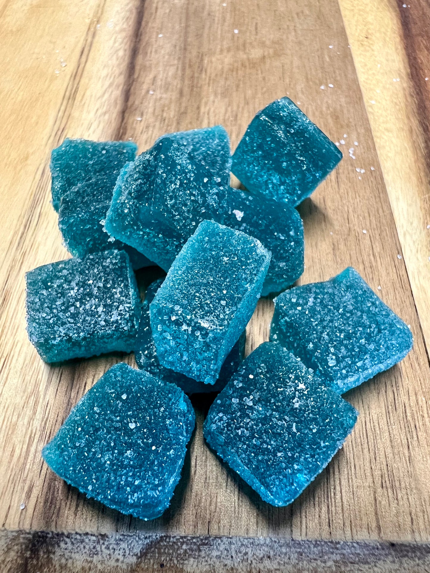 Blue Raspberry cbd gummies on wooden plank